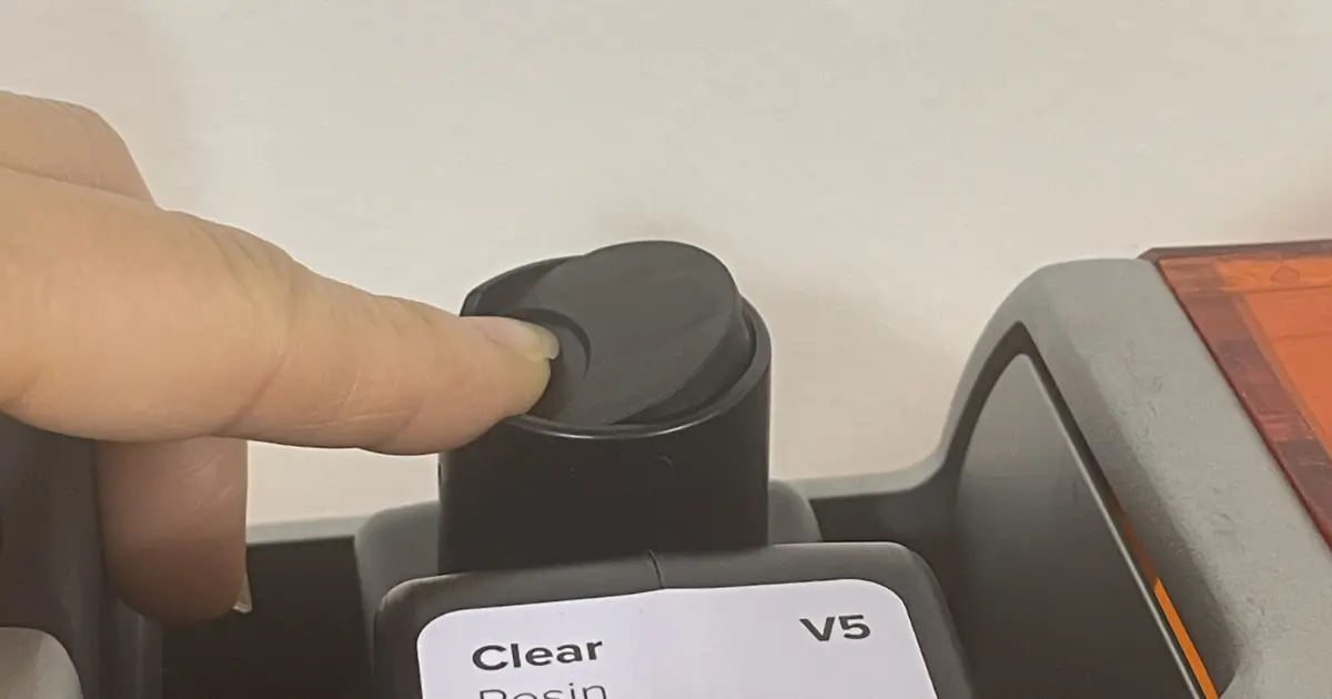 レジンカートリッジ上部の空気抜きキャップを開ける様子