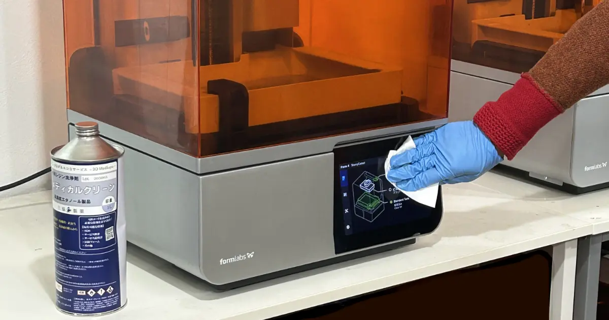 Form 4のカバーハンドルを洗浄液3D Medsupoで拭き上げる様子